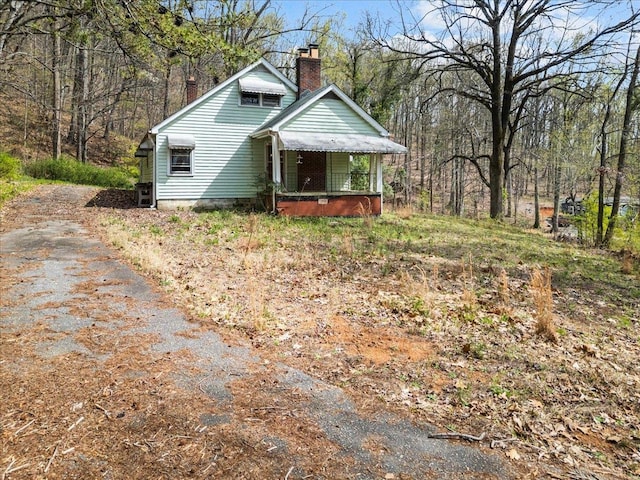 239 Phillips, Greenville, SC 29609 - view of front of home with a chimney and aphalt driveway