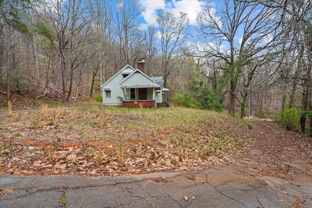 239 Phillips, Greenville, SC 29609 - view of front of house with a wooded view and a chimney