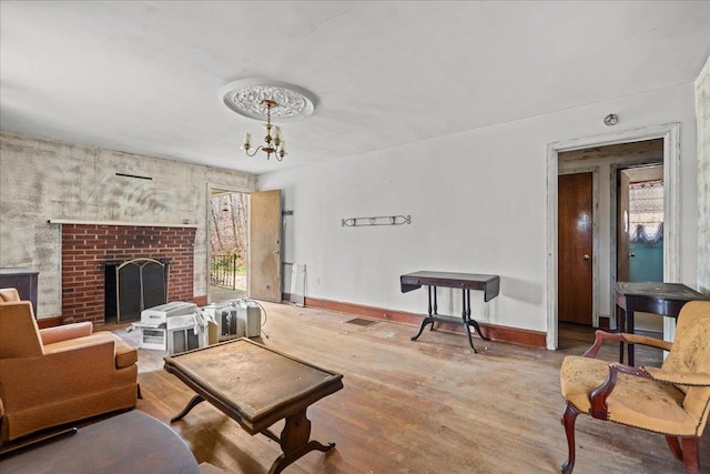 239 Phillips, Greenville, SC 29609 - living area featuring an inviting chandelier, baseboards, a healthy amount of sunlight, and wood finished floors