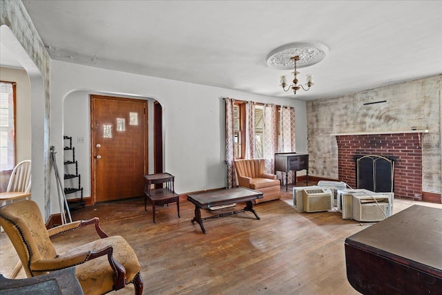 239 Phillips, Greenville, SC 29609 - living room with arched walkways, a fireplace, a notable chandelier, and hardwood / wood-style flooring