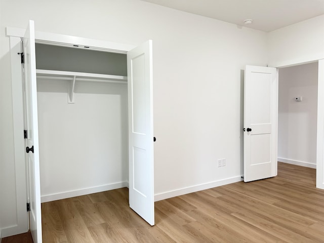 732 Corn Ml, Cowpens, SC 29330 - unfurnished bedroom featuring light wood-style flooring, a closet, and baseboards