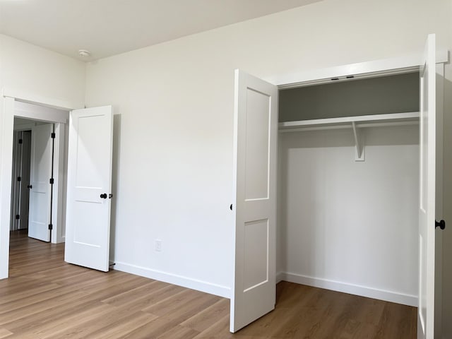 732 Corn Ml, Cowpens, SC 29330 - unfurnished bedroom featuring wood finished floors, baseboards, and a closet