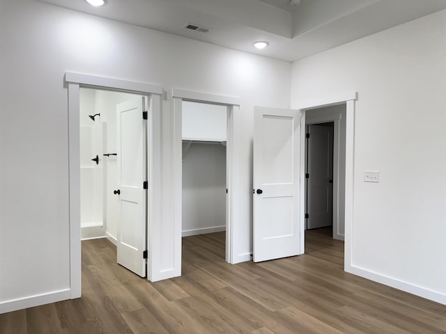 732 Corn Ml, Cowpens, SC 29330 - unfurnished bedroom featuring wood finished floors, baseboards, a walk in closet, recessed lighting, and a closet