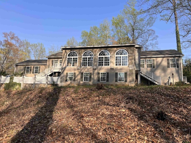 rear view of house featuring stairway