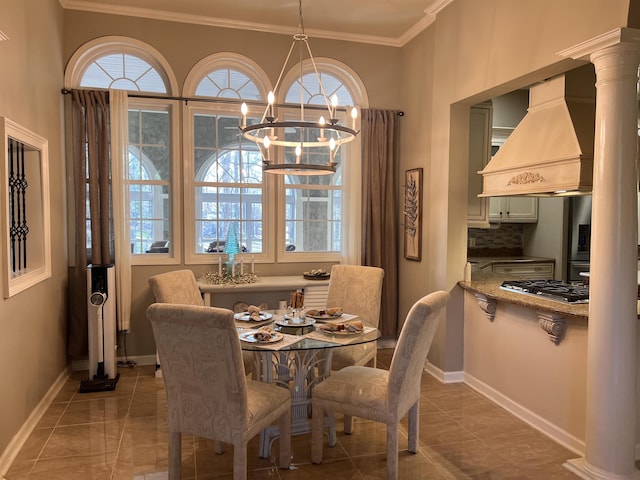 dining space featuring baseboards, a notable chandelier, tile patterned flooring, and ornamental molding