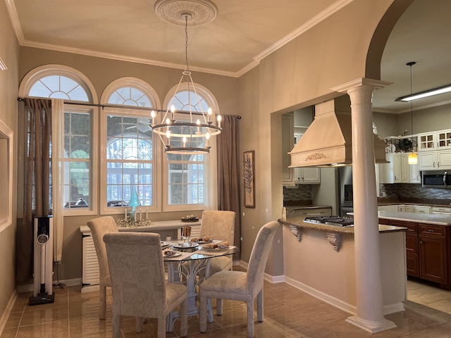 dining space featuring plenty of natural light, baseboards, a notable chandelier, and ornamental molding
