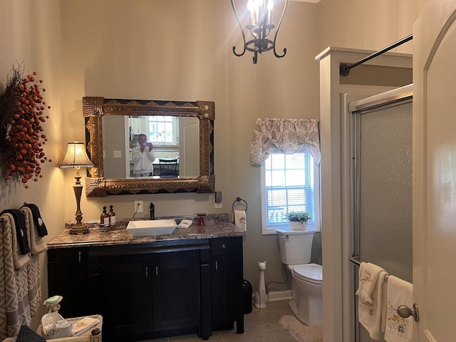 full bath with a chandelier, toilet, tile patterned floors, vanity, and a stall shower