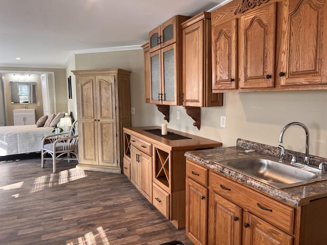 kitchen with a sink, brown cabinetry, and dark wood finished floors