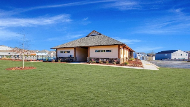 view of front of house featuring a front yard and stone siding
