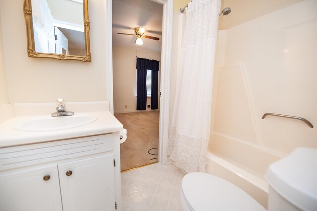 bathroom with vanity, toilet, shower / tub combo, and a ceiling fan