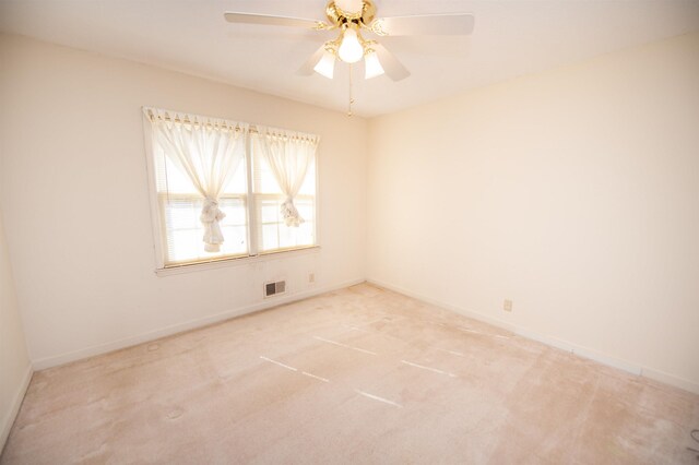 spare room with visible vents, carpet, baseboards, and ceiling fan