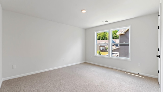 carpeted spare room with baseboards