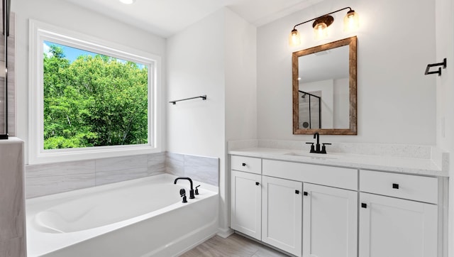 full bath featuring a bath, vanity, and a stall shower