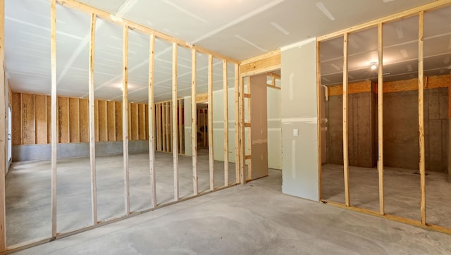 miscellaneous room with unfinished concrete floors