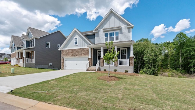 craftsman-style home featuring board and batten siding, a porch, concrete driveway, a front lawn, and brick siding