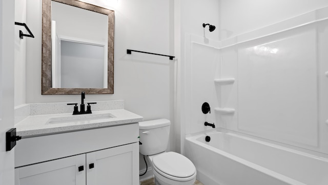bathroom featuring toilet, vanity, and shower / bathtub combination