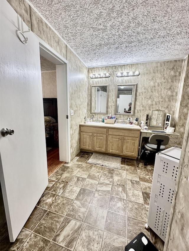 bathroom with a sink, ensuite bathroom, and double vanity