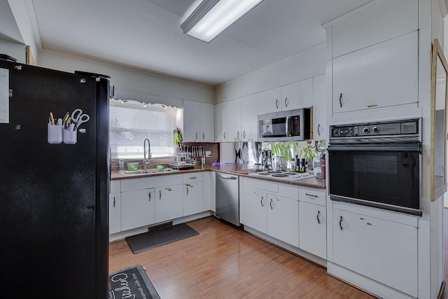 129 Canty, Gaffney, SC 29341 - kitchen with light wood finished floors, dark countertops, white cabinetry, a sink, and black appliances