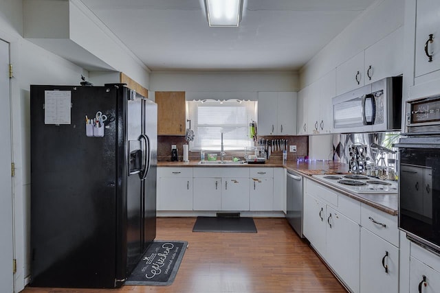 129 Canty, Gaffney, SC 29341 - kitchen with backsplash, a sink, white cabinetry, wood finished floors, and black appliances