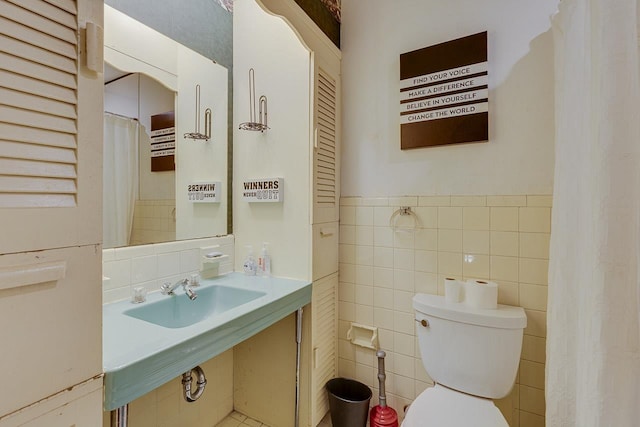 129 Canty, Gaffney, SC 29341 - full bath featuring tile walls, toilet, a sink, and wainscoting