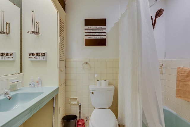 129 Canty, Gaffney, SC 29341 - bathroom featuring a wainscoted wall, tile walls, toilet, vanity, and shower / bath combination with curtain