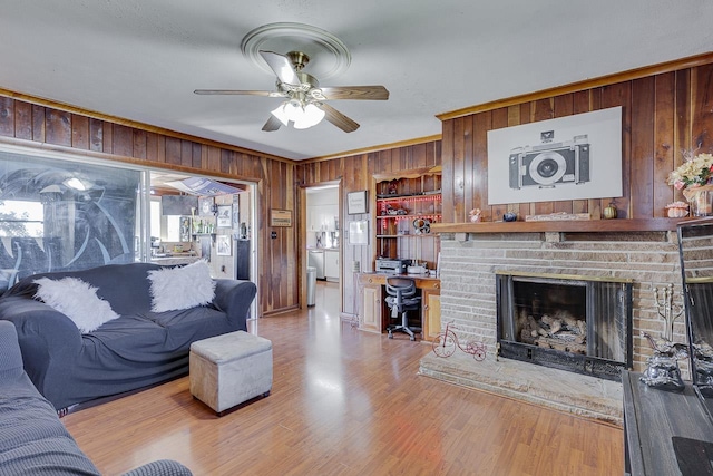 129 Canty, Gaffney, SC 29341 - living area featuring crown molding, wooden walls, a fireplace, wood finished floors, and a ceiling fan