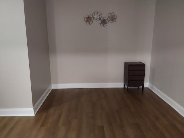 unfurnished room with wood finished floors and baseboards