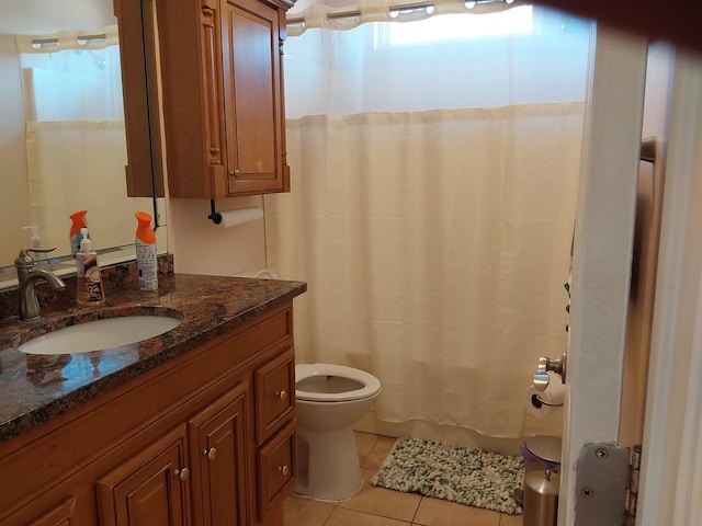 bathroom with vanity, toilet, tile patterned flooring, and shower / bath combo with shower curtain