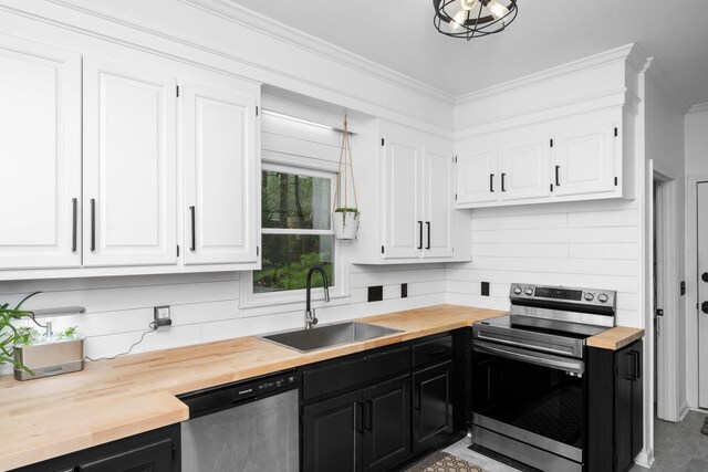 kitchen featuring a sink, wood counters, and appliances with stainless steel finishes