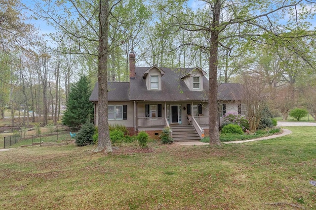 cape cod house with a front yard, a porch, fence, and a chimney