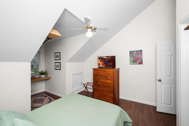 bedroom with baseboards, lofted ceiling, and wood finished floors