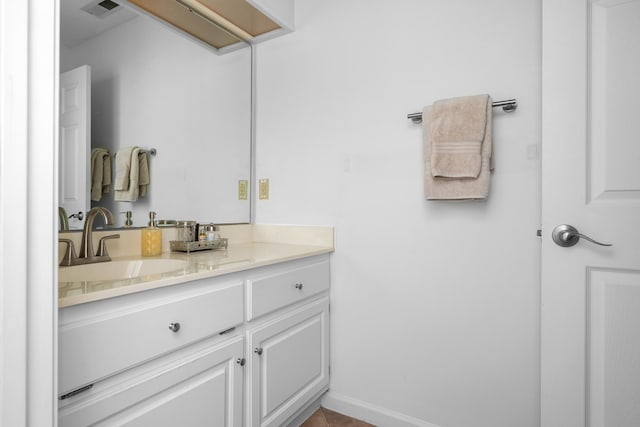 bathroom featuring baseboards, visible vents, and vanity