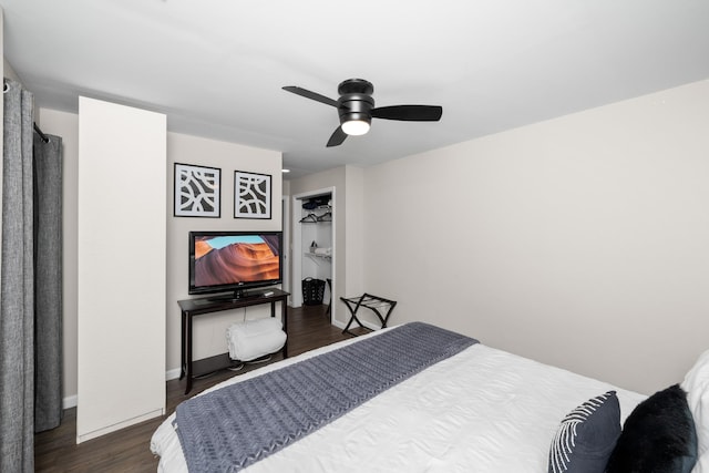 bedroom featuring baseboards, ceiling fan, and dark wood finished floors