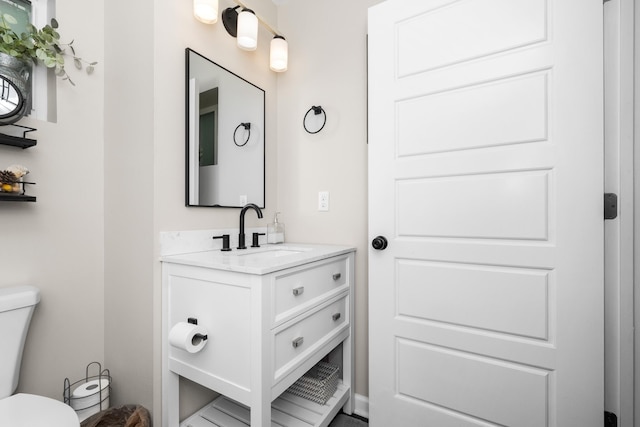 half bathroom featuring toilet and vanity