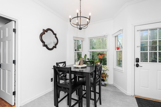 dining room featuring plenty of natural light, baseboards, ornamental molding, and an inviting chandelier