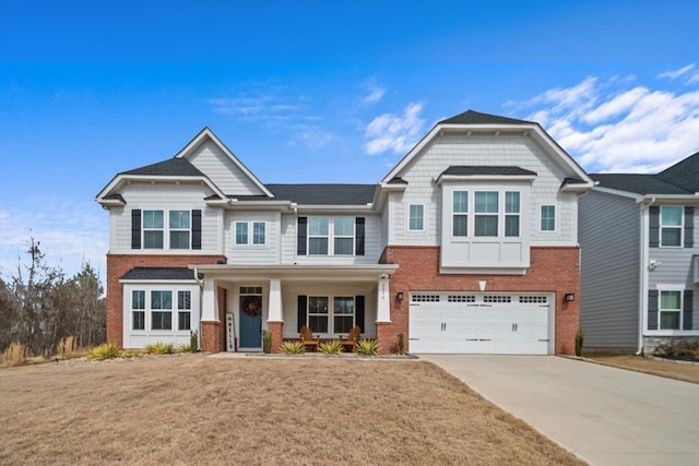 2046 Bluet, Woodruff, SC 29388 - view of front of house with a garage, a porch, a front lawn, brick siding, and driveway