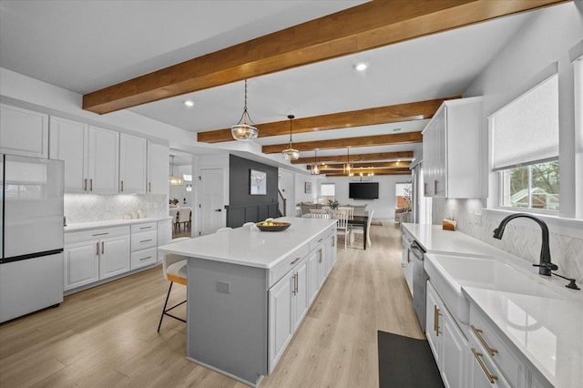 2046 Bluet, Woodruff, SC 29388 - kitchen featuring a kitchen breakfast bar, freestanding refrigerator, a kitchen island, white cabinets, and light wood-style floors