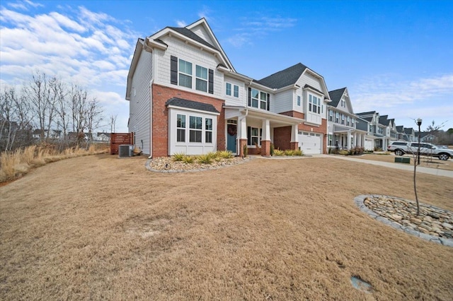 2046 Bluet, Woodruff, SC 29388 - view of front facade with central AC unit, a garage, concrete driveway, brick siding, and a residential view