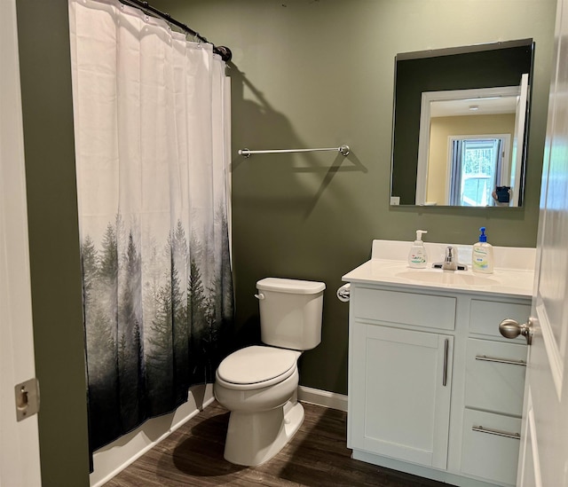 bathroom featuring vanity, toilet, wood finished floors, a shower with shower curtain, and baseboards