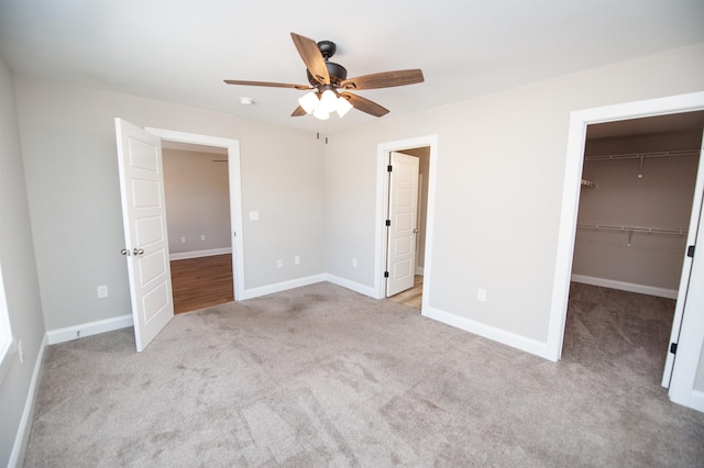100 Winterhaven, Spartanburg, SC 29301 - unfurnished bedroom with a closet, baseboards, carpet flooring, a ceiling fan, and a walk in closet
