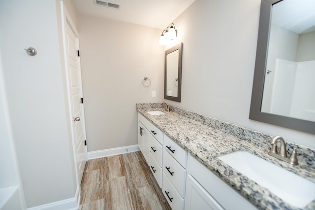 100 Winterhaven, Spartanburg, SC 29301 - bathroom featuring double vanity, visible vents, baseboards, and a sink