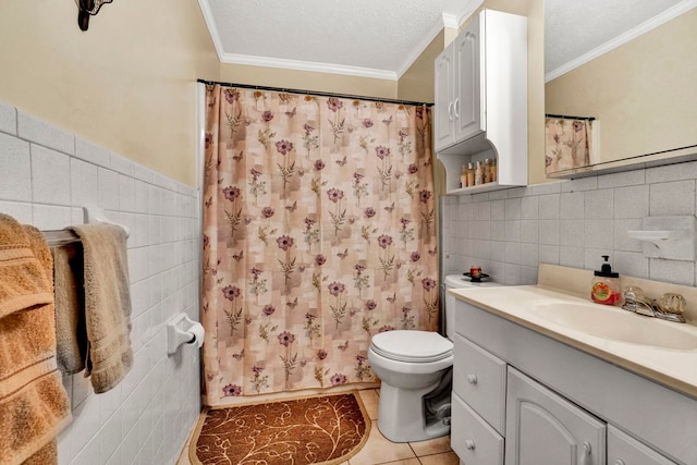 bathroom with a textured ceiling, vanity, ornamental molding, and tile walls