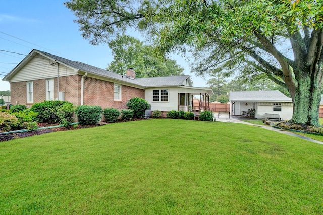 single story home with covered porch, a chimney, an outdoor structure, brick siding, and a front lawn