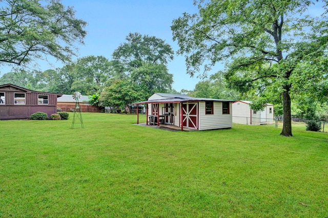 view of yard featuring an outbuilding and fence