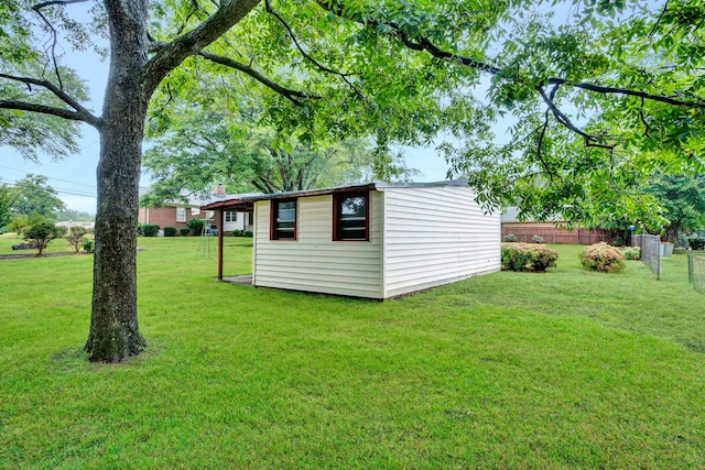 view of yard featuring an outdoor structure and fence