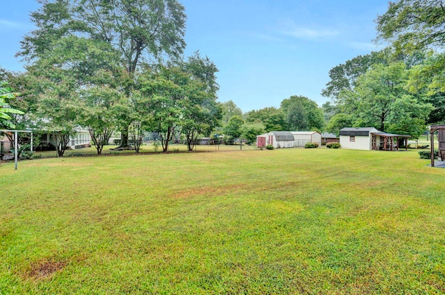 view of yard with an outdoor structure and fence