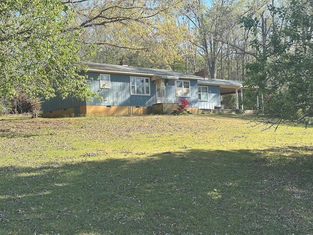 view of front of home featuring a front yard, crawl space, and a chimney