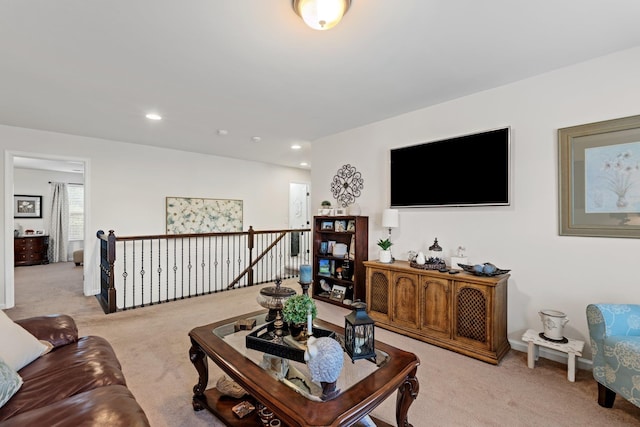 living area with recessed lighting and light colored carpet