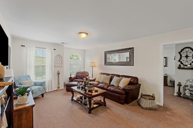 carpeted living room with baseboards and visible vents