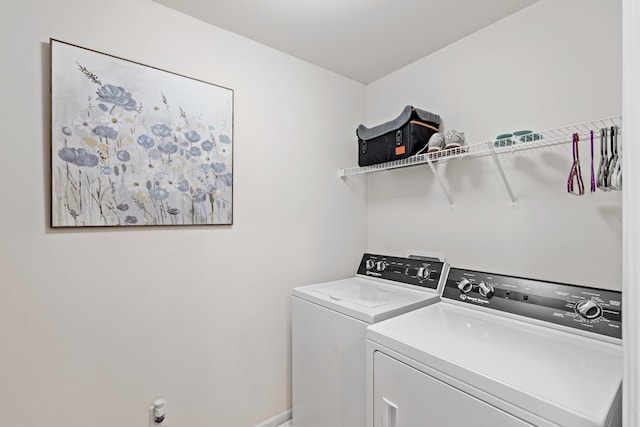 laundry area featuring washer and dryer, laundry area, and baseboards